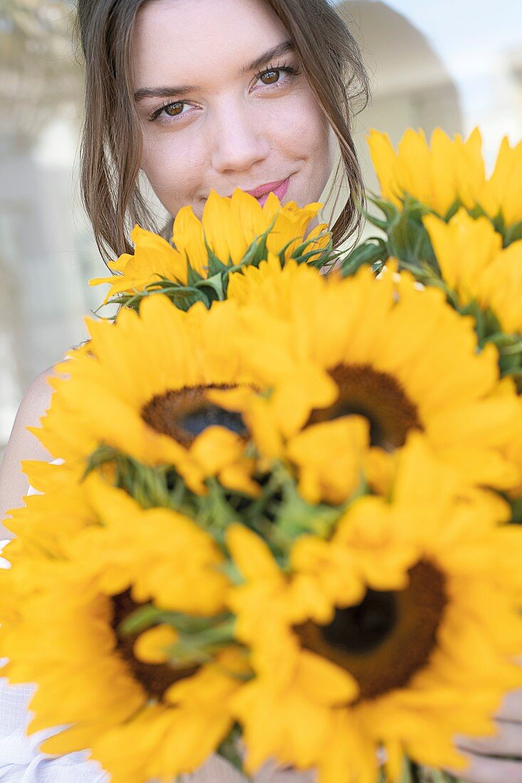 Young woman with sunflowers