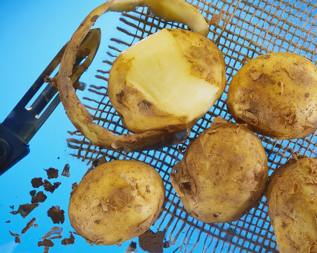 Whole Potatoes; One Partially Peeled