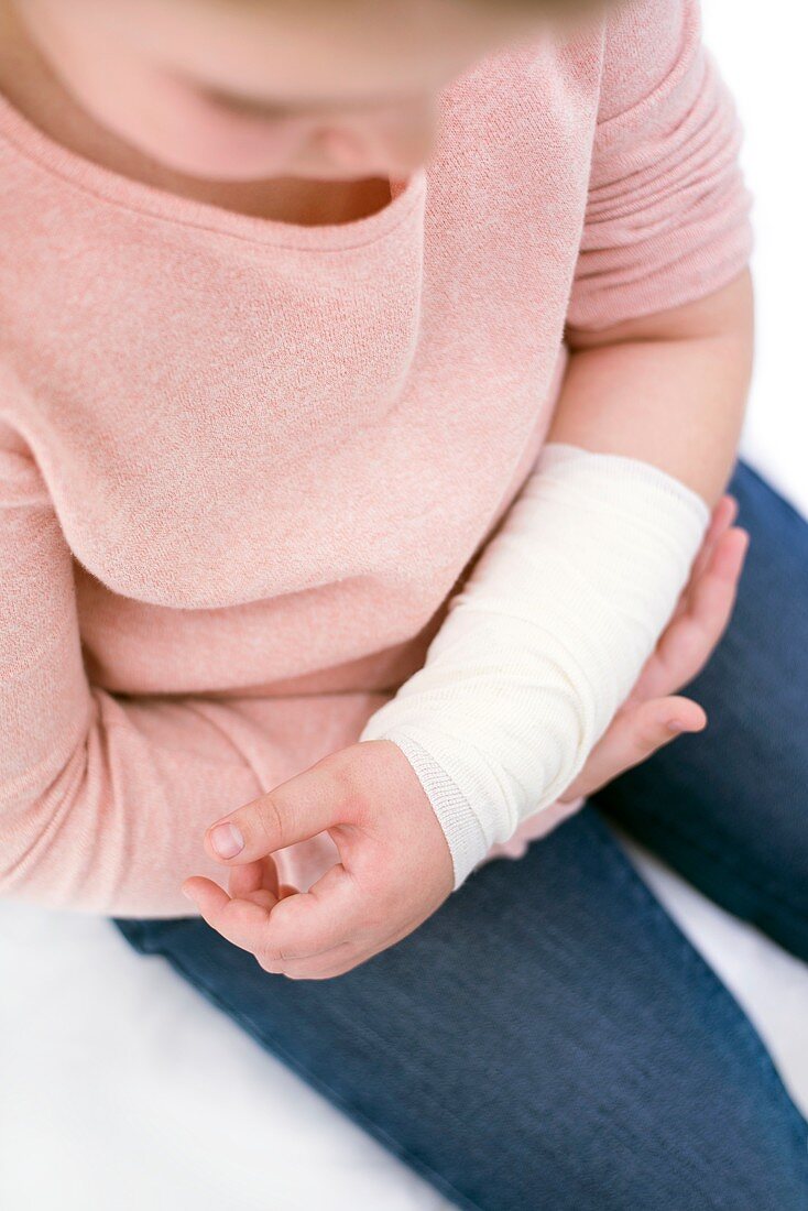 Girl with bandaged arm