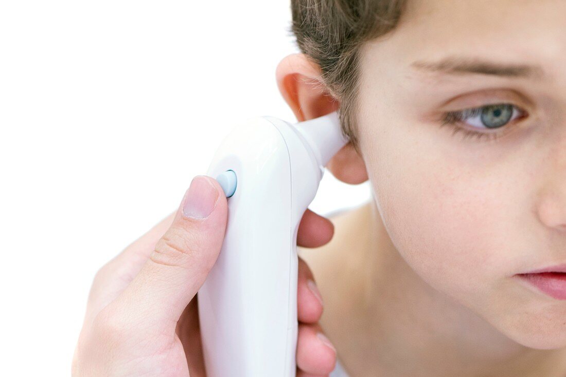 Boy having his temperature taken