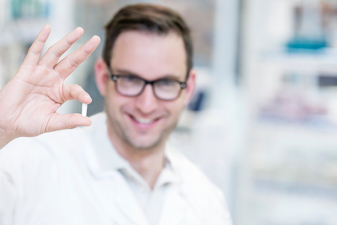 Pharmacist holding pill