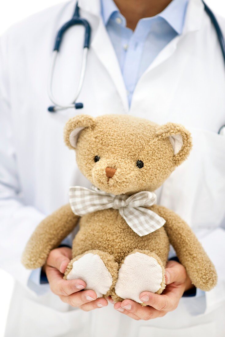 Doctor holding teddy bear