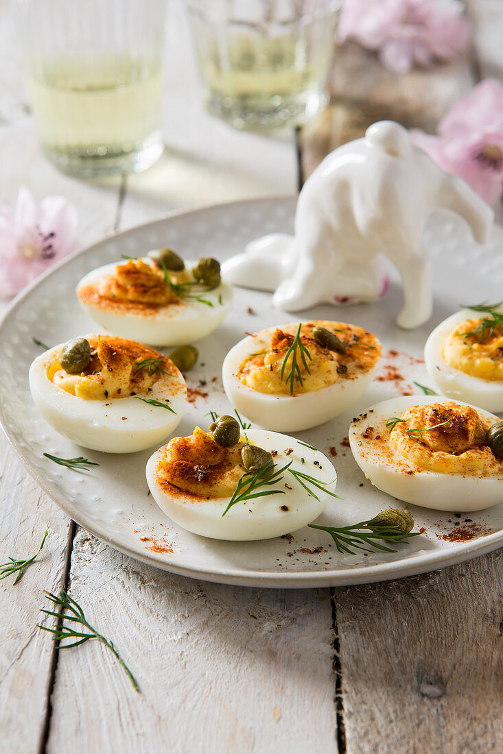 Easter deviled eggs on a serving plate with bunny