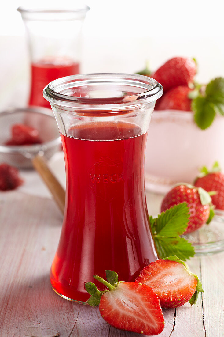 Homemade strawberry vinegar with fresh berries, apple vinegar and acacia honey