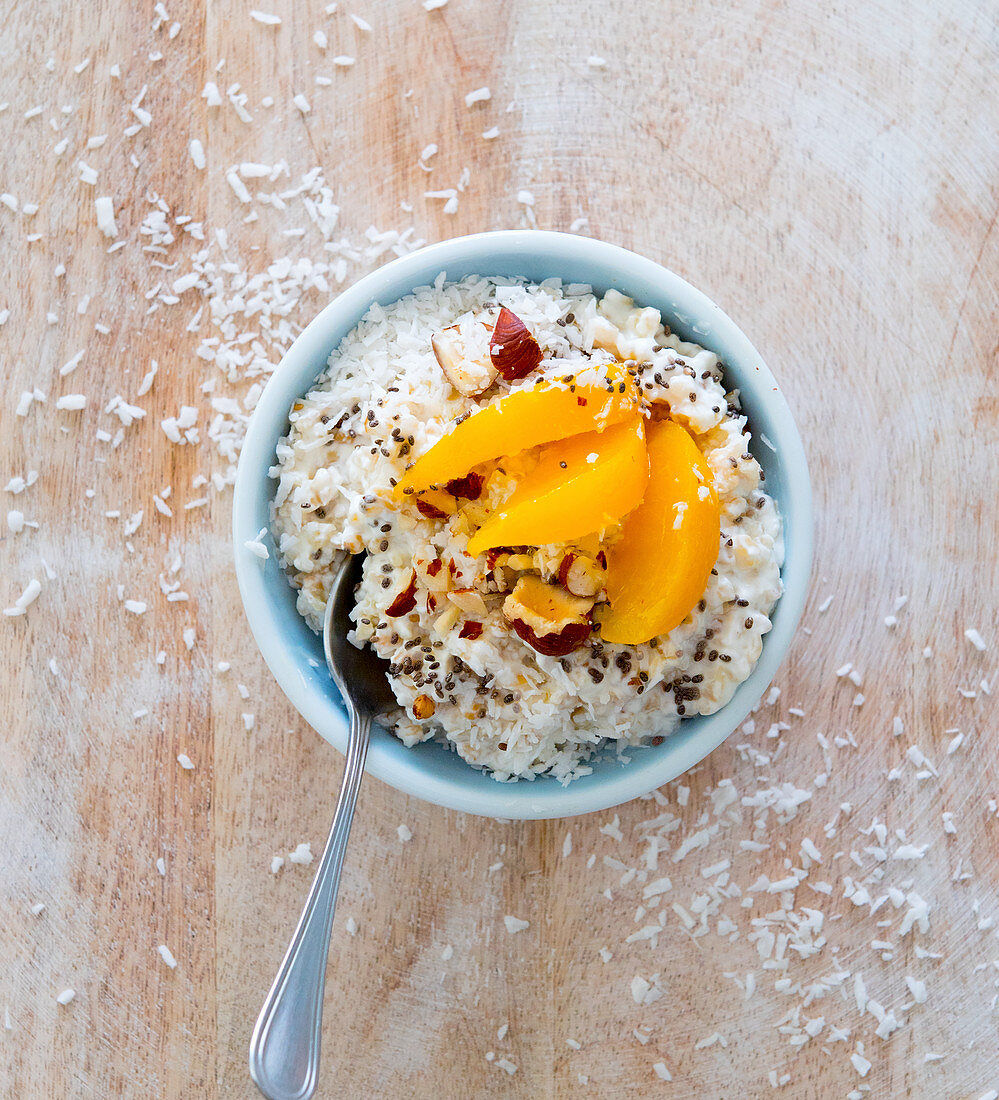 Coconut rice pudding with peaches and hazelnuts