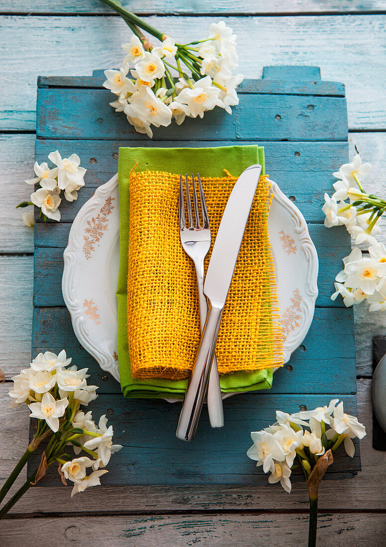 Spring table setting - narcissus flower, Fork and knife on Easter table