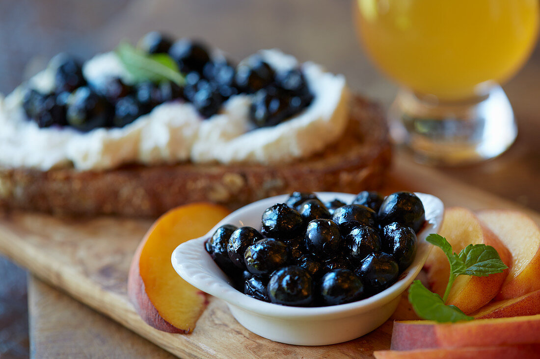 A slice of bread topped with ricotta and blueberries