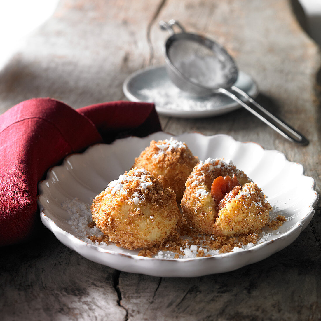 Damson dumplings roasted in butter with breadcrumbs and icing sugar