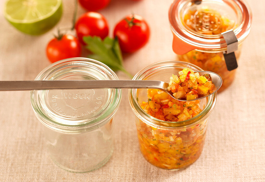 Tomato salsa with cumin in jars