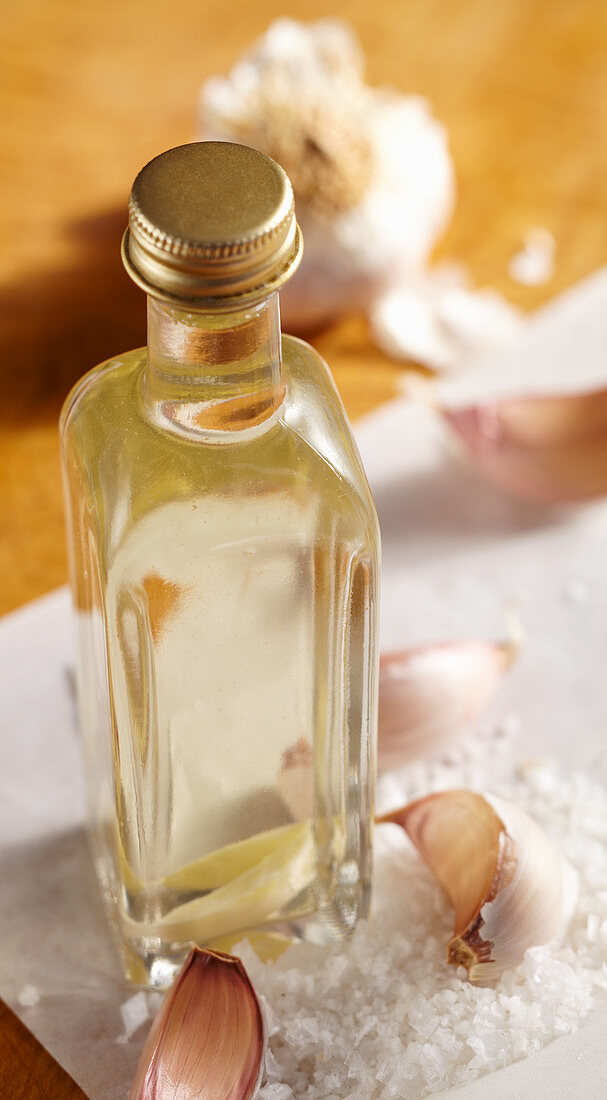 Homemade garlic vinegar with sea salt in a glass bottle