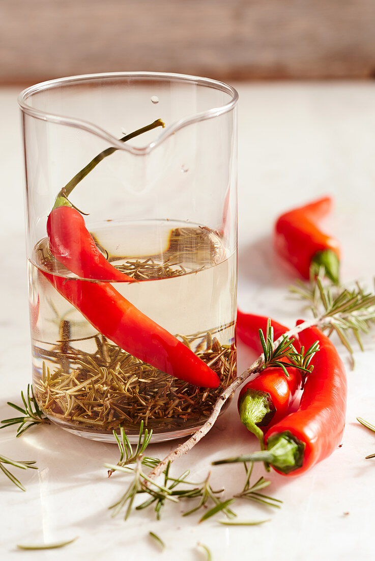 Homemade tequila and rosemary vinegar with fresh red chili