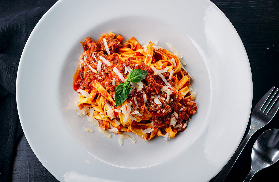 Tasty Italian pasta with meat sauce and grated cheese