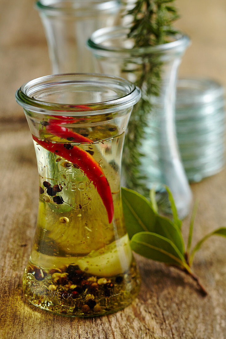 Homemade seasoning oil with garlic, chili, herbs of Provence and olive oil