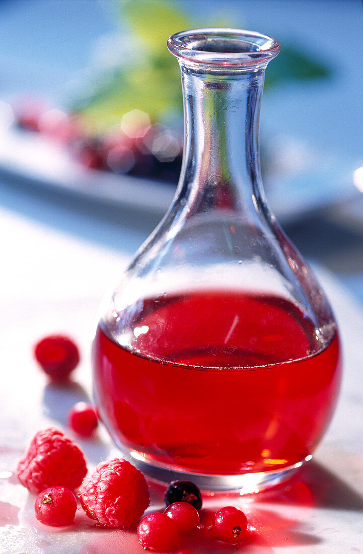 Homemade red berry vinegar in a glass bottle