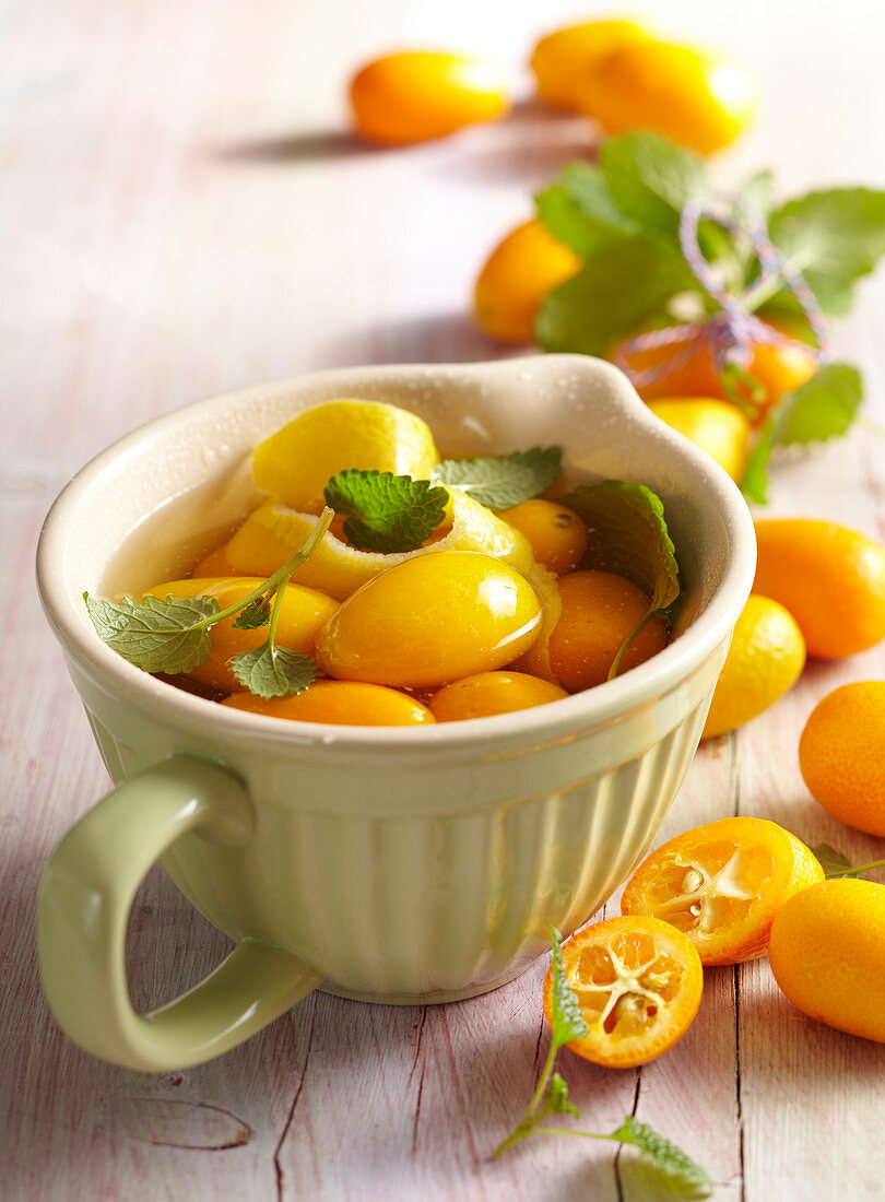 Homemade kumquat vinegar with lemon balm