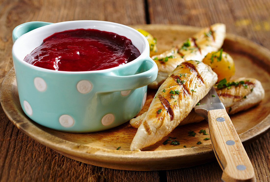 Homemade cherry ketchup served with grilled chicken strips