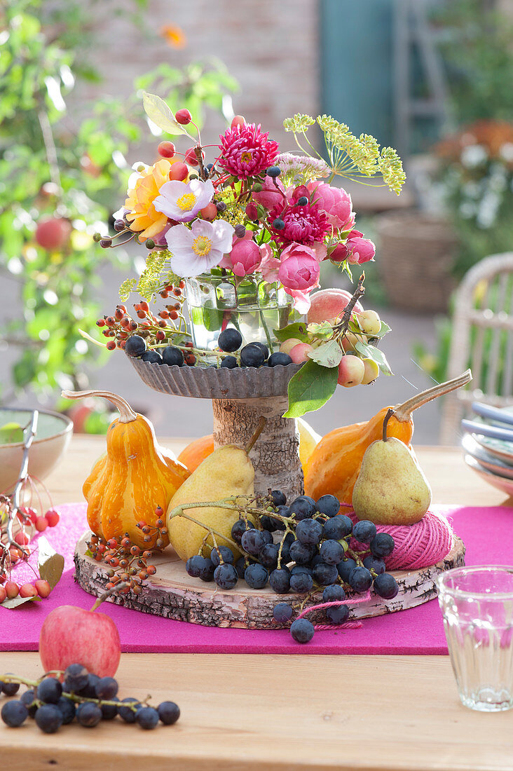 Homemade cake stands with grapes and pumpkin as a thanksgiving decoration