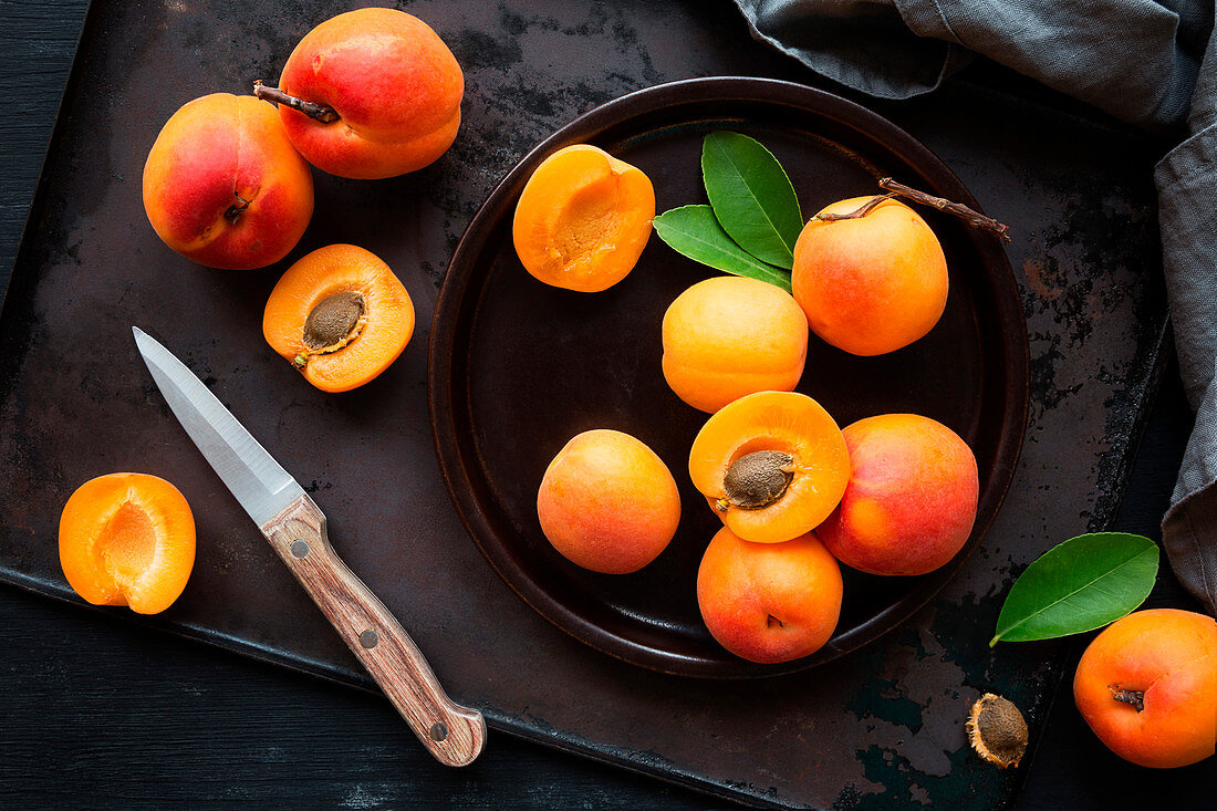 Fresh ripe apricots on brown rustic background