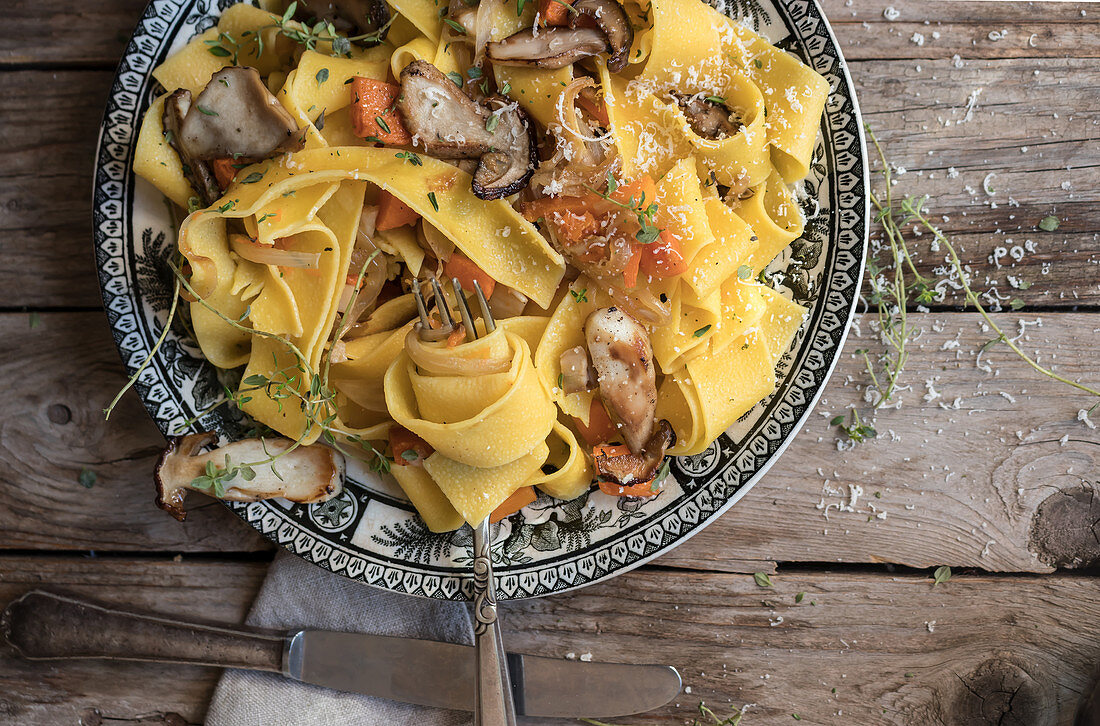Plate with prepared pappardelle with pumpkin and boletus