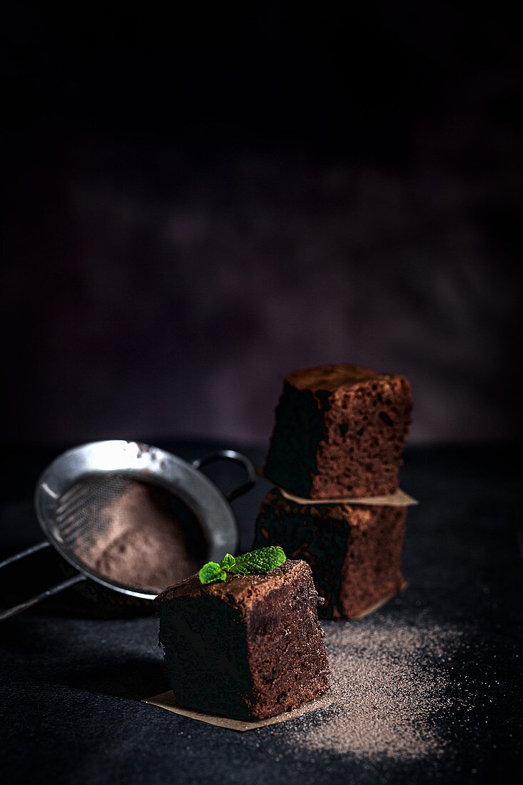 Chocolate brownie with mint on dark background