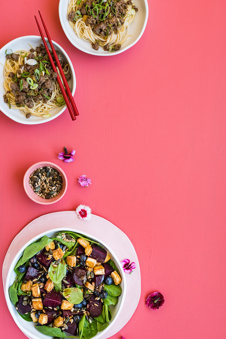Spicy ostrich dan-dan noodles, blueberry-and-beetroot salad with crispy tofu and mixed seeds