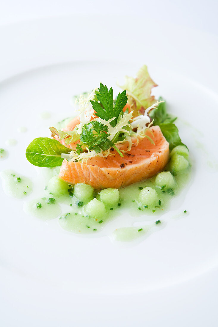 Salmon on cucumber pearls with herb salad