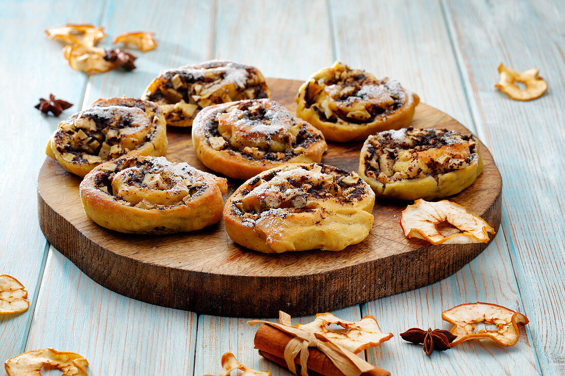 Poppy pastries with apple and cinnamon on a wooden board