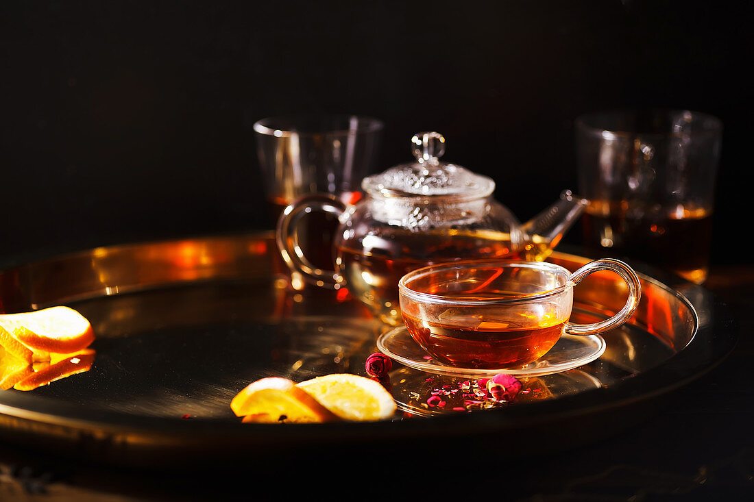 Teapot and glass cups with black tea