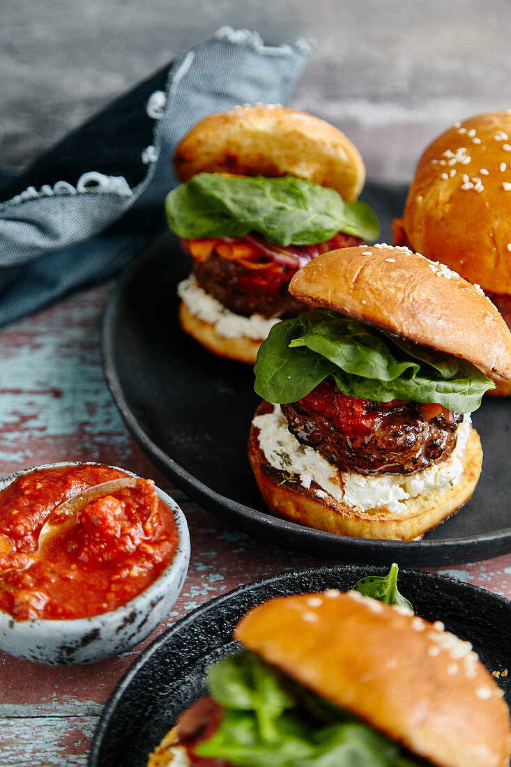 Burgers with grilled beef patties, cream cheese and spinach on classical bun
