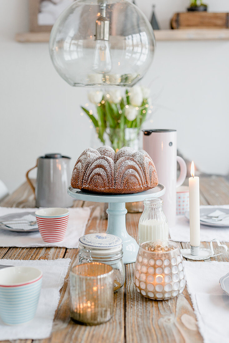 A Bundt cake made with eggnog on a table decorated for spring