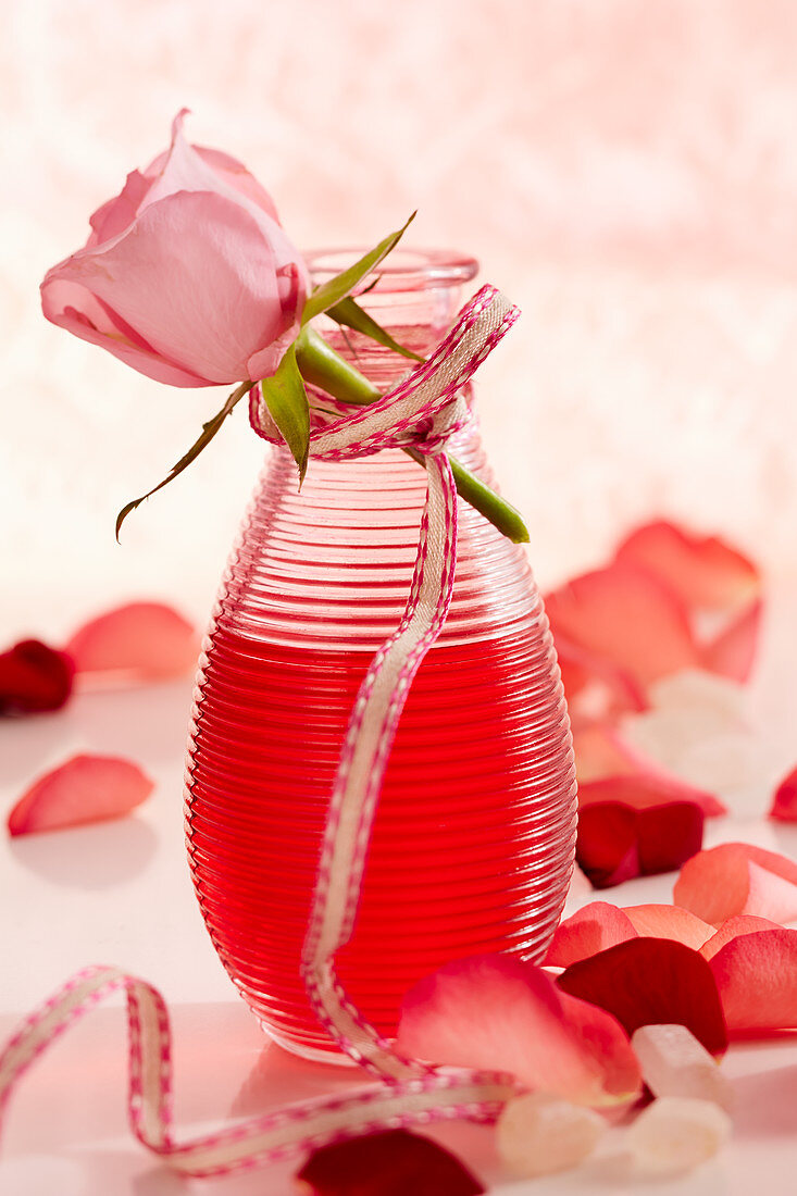 Homemade rose liqueur with fresh rose petals as a gift