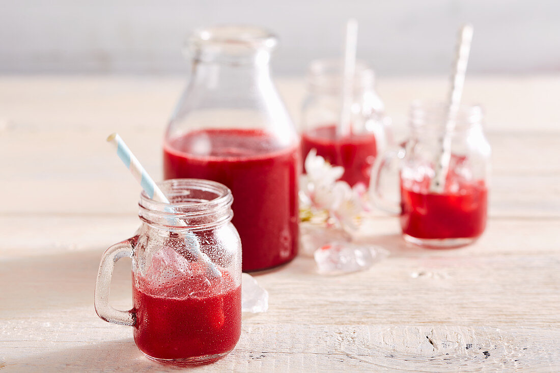 Homemade sour cherry liqueur in a bottle and glasses