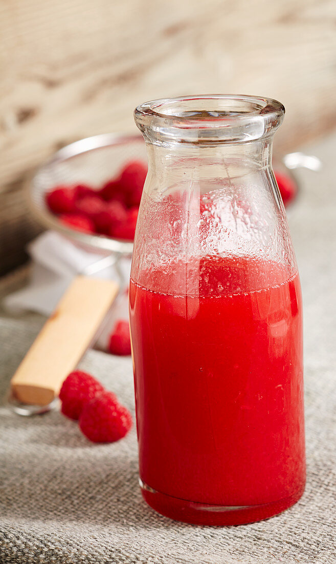 Homemade raspberry liqueur with vodka and raspberry spirit