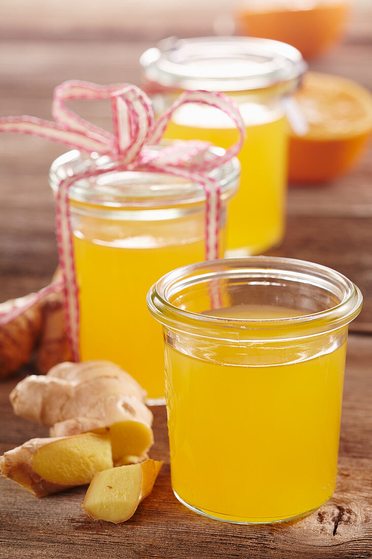 Homemade orange and ginger syrup in mason jars