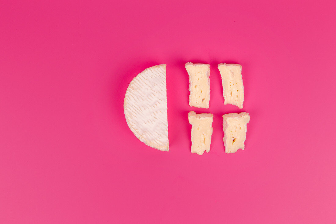 A halved Camembert and sliced Camembert