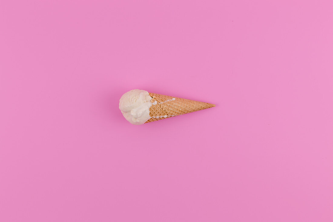A scoop of vanilla ice cream in a cone