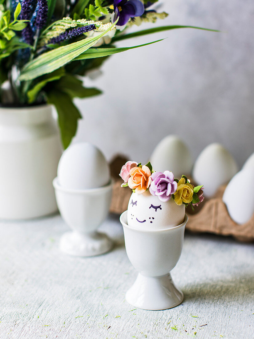 Easter eggs with flower decorations in eggcups