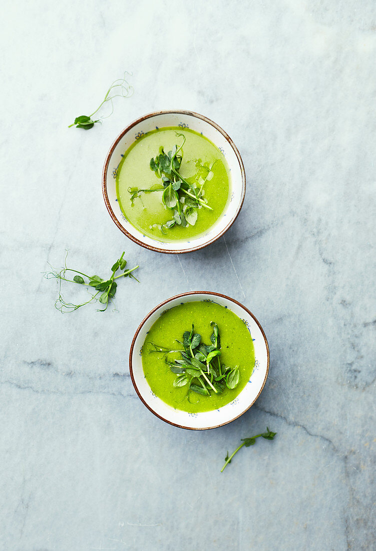 Green pea and spinach soup topped with pea sprouts and basil