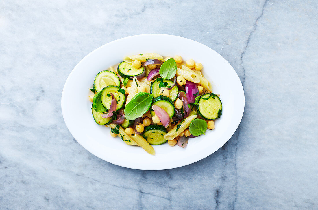 Penne pasta with courgette, red onion and chickpeas