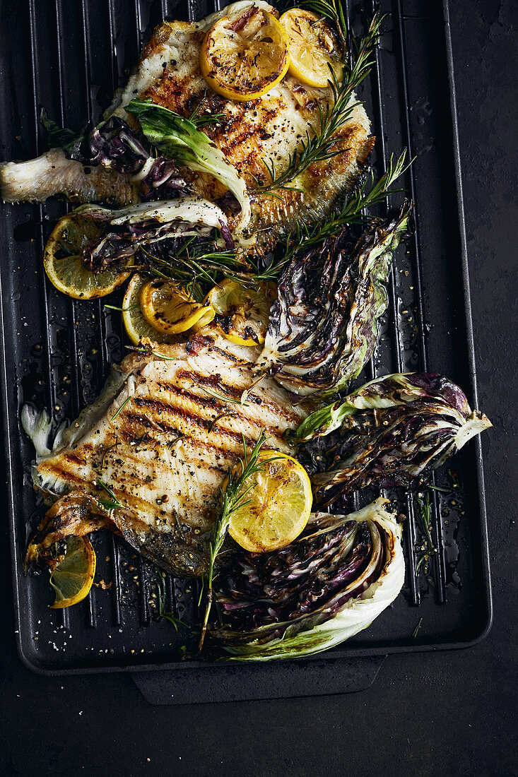 Ray fish, radicchio and lemons on a grill