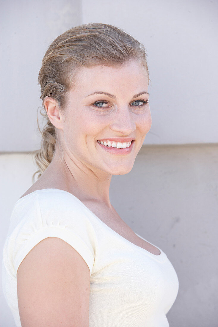 A blonde woman wearing a white shirt