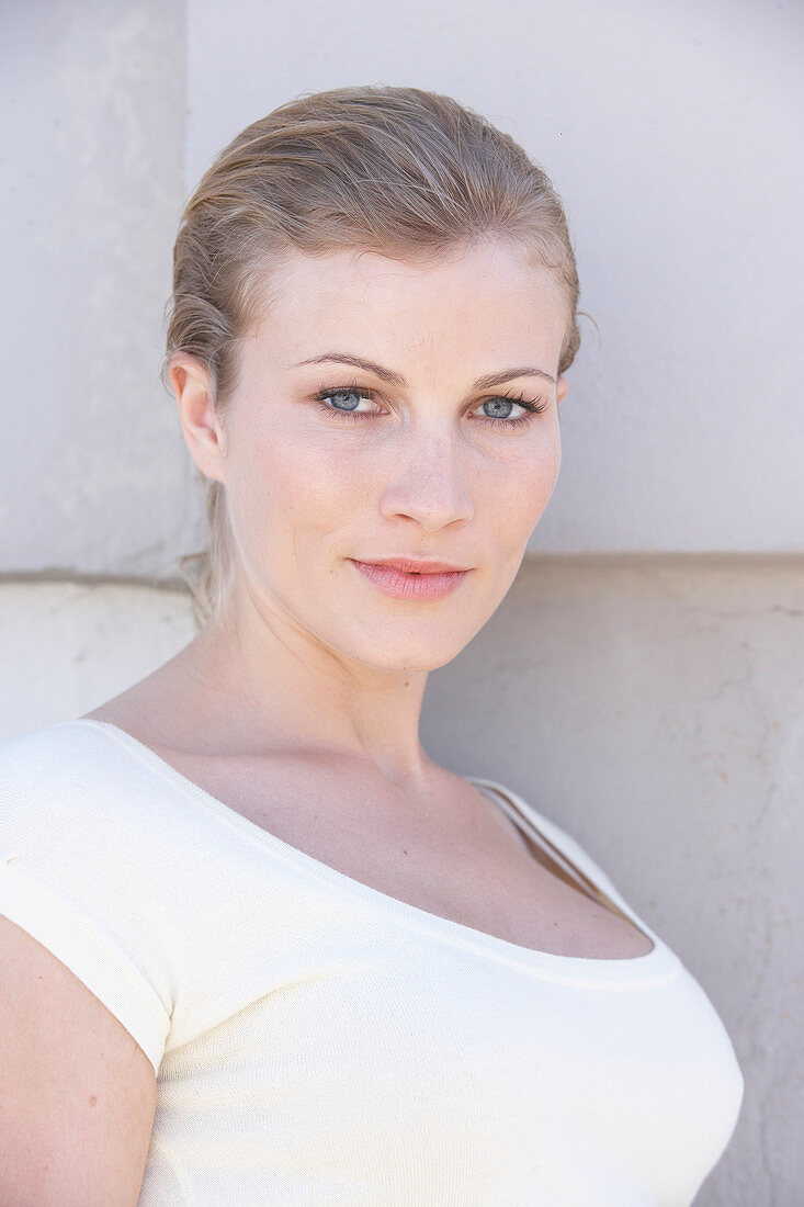 A blonde woman wearing a white shirt