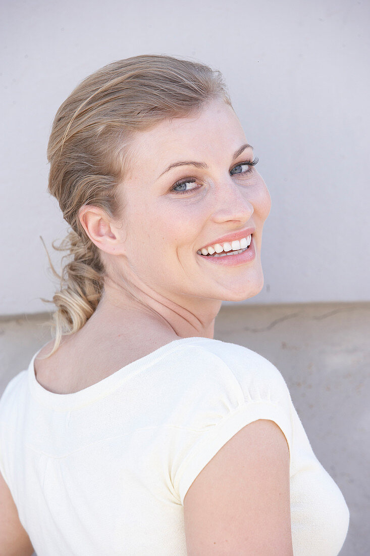 A blonde woman wearing a white shirt