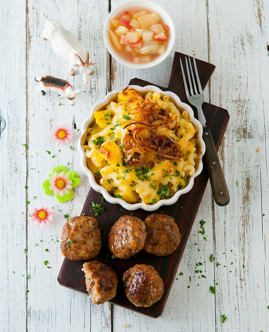Swiss meatballs (Hacktätschli) with apple compote and Älplermagronen (a dish from the Swiss Alps made from pasta, potatoes, cheese, cream and onions)