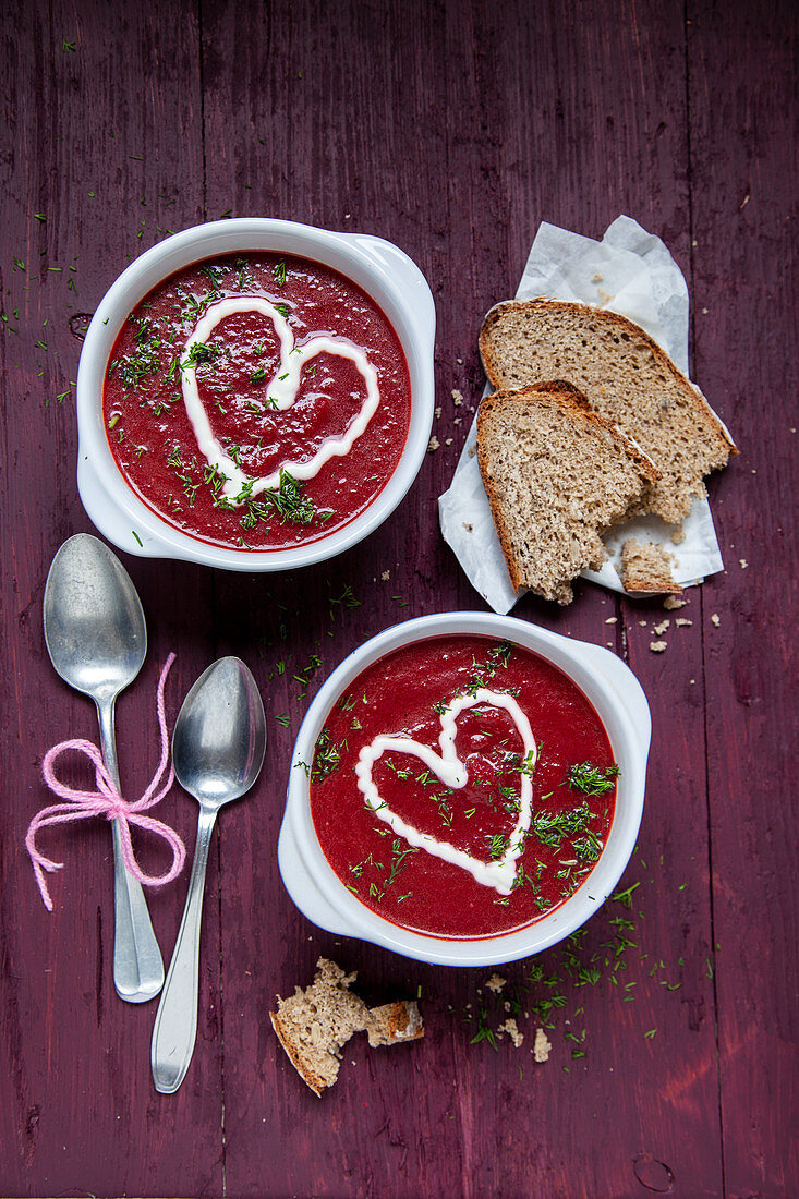 Beetroot soup garnished with yoghurt hearts and dill