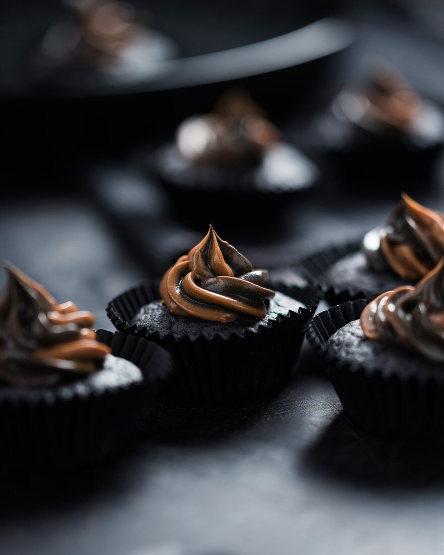 Vegan blood orange cupcakes, coloured with active charcoal with two-tone nougat frosting