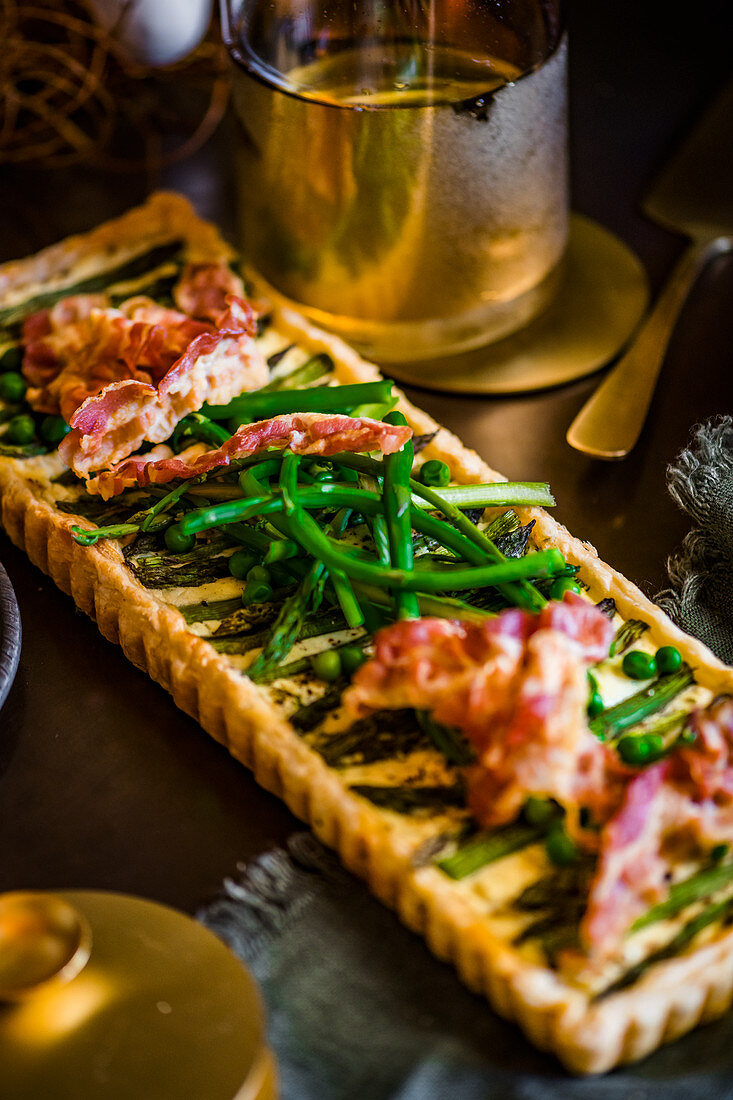 A tart with green asparagus, peas and bacon for an Easter high tea
