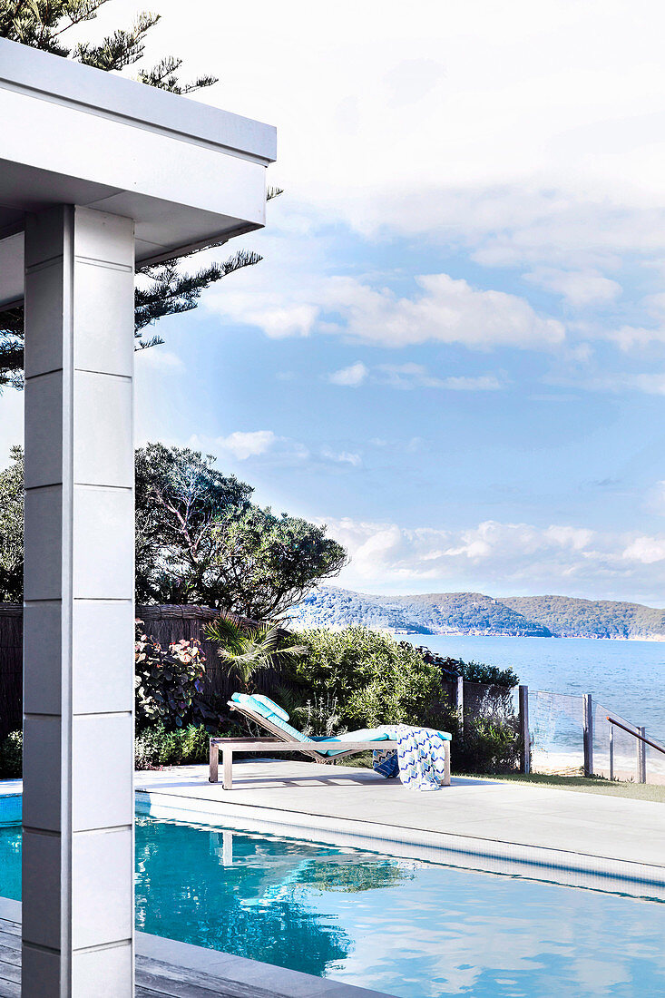 View of pool and lounger, in the background the sea