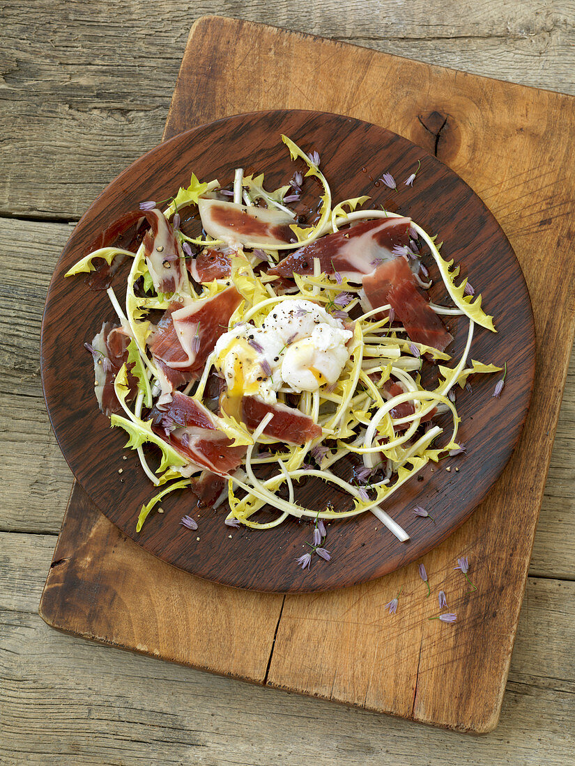 Dandelion salad with Iberico ham and a poached egg