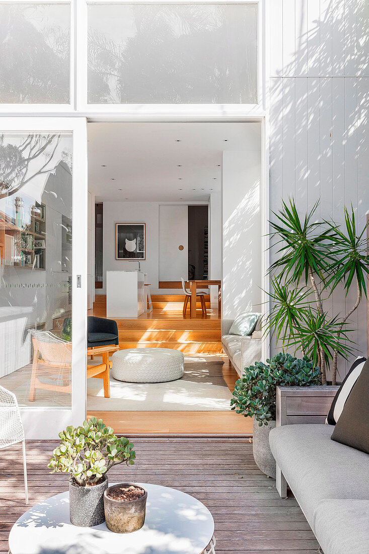 View from the terrace into a bright, open living room